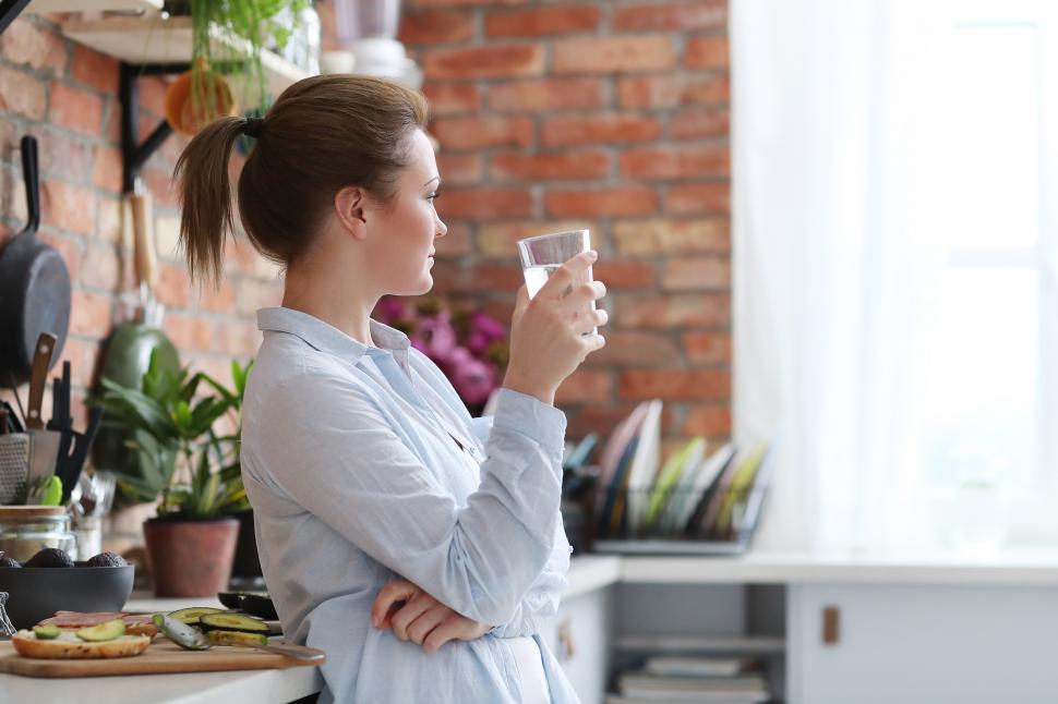Free Image of Woman looking out the window 