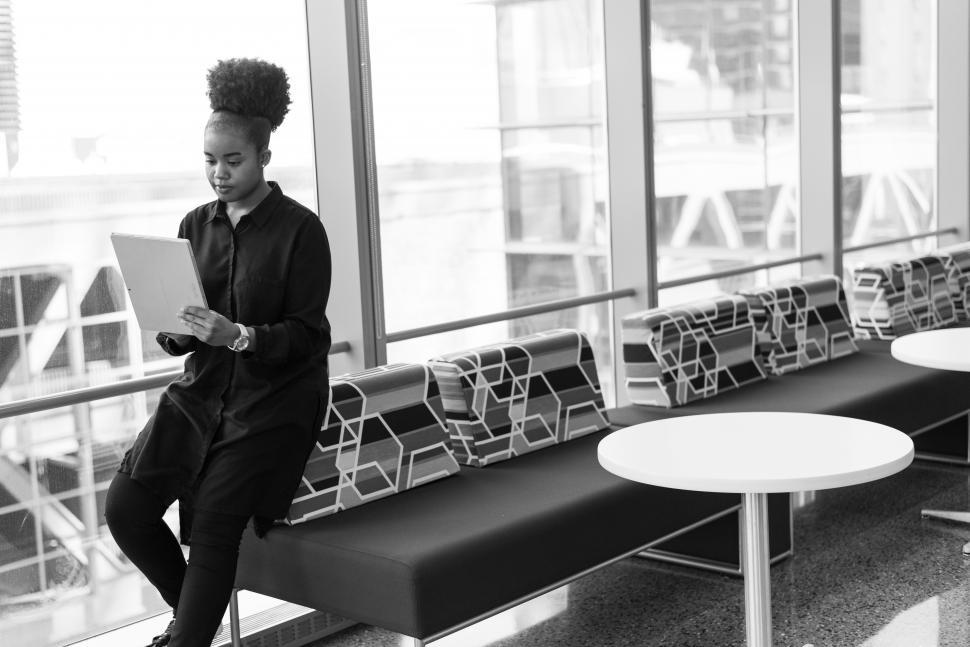 Free Image of Woman holding tablet computer in office - b&w 