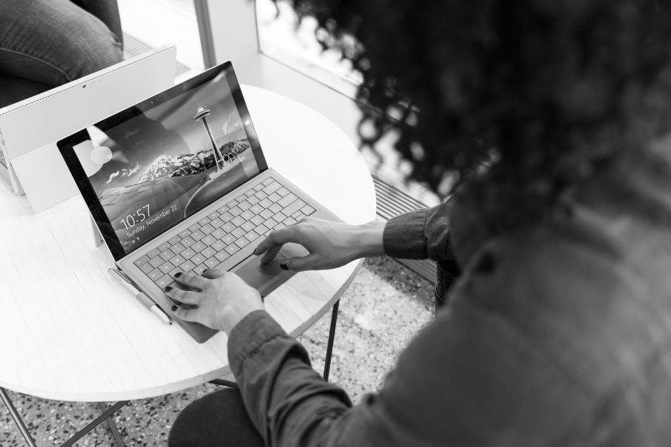 Free Image of Woman typing on laptop keyboard - b&w 