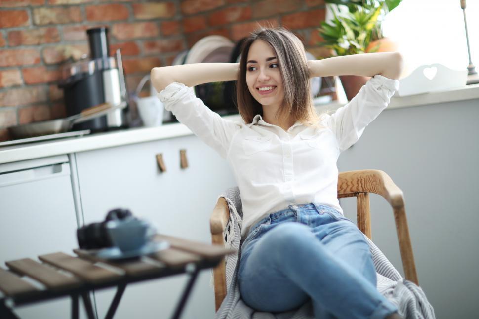 Free Image of Woman with hands clasped behind her head 