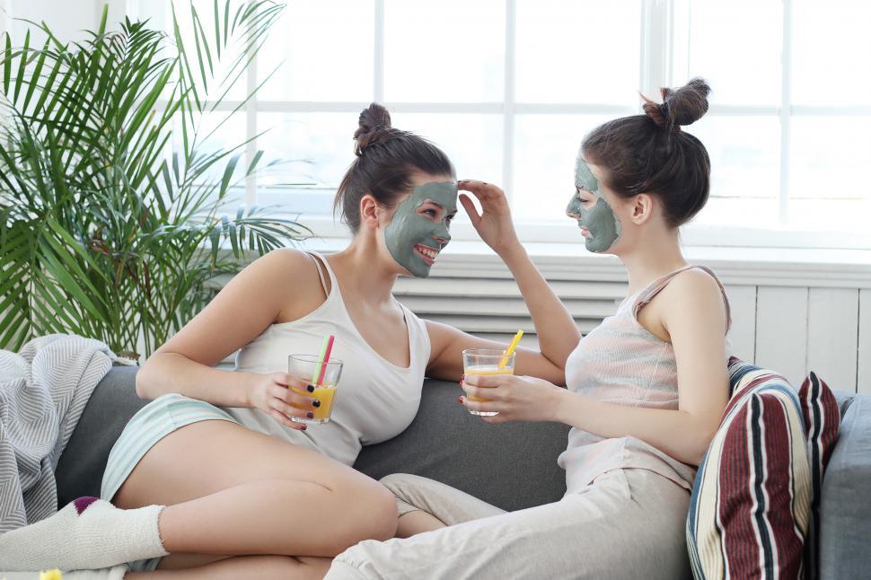 Free Image of Women laugh together with face masks 