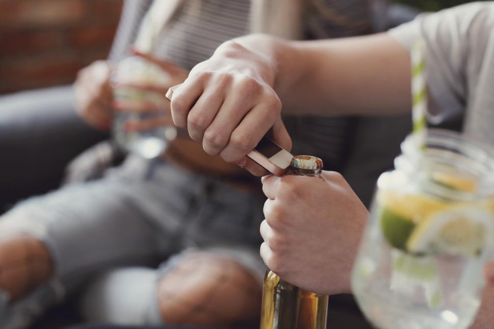 Free Image of Person opening a beer bottle 