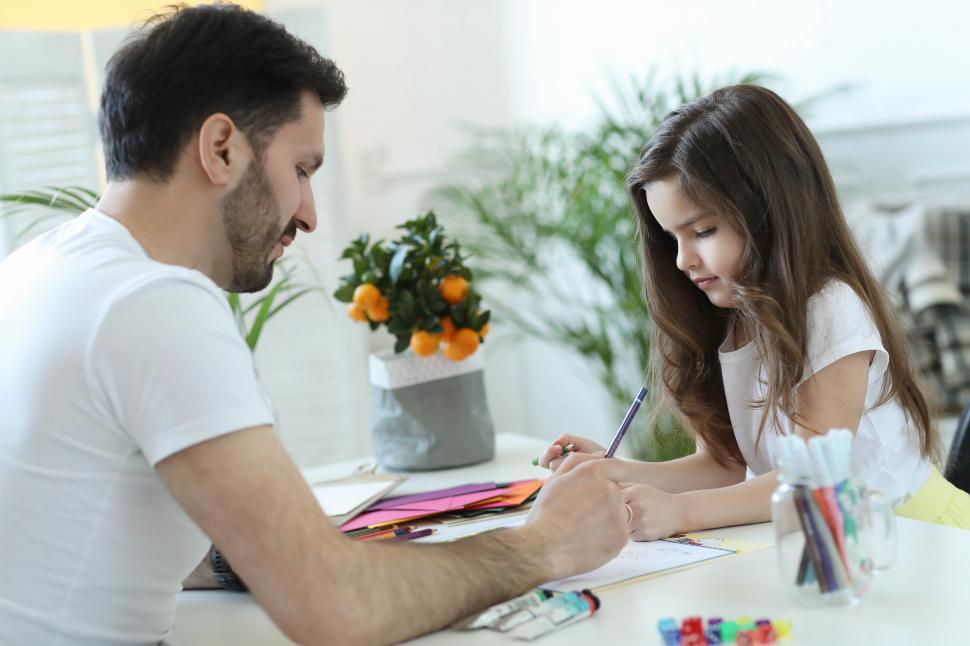 Free Image of Father and Daughter Drawing Together 