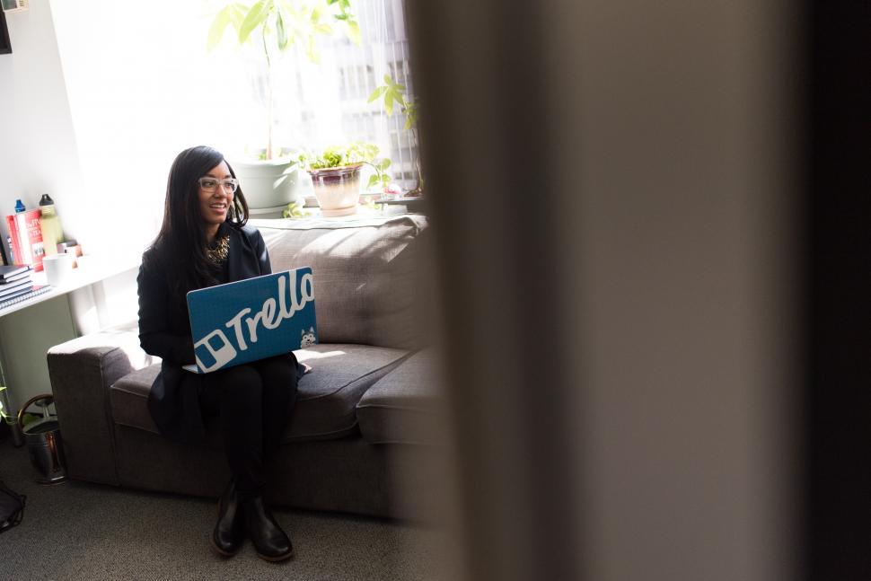 Free Image of Stylish female executive in glasses with laptop on sofa 