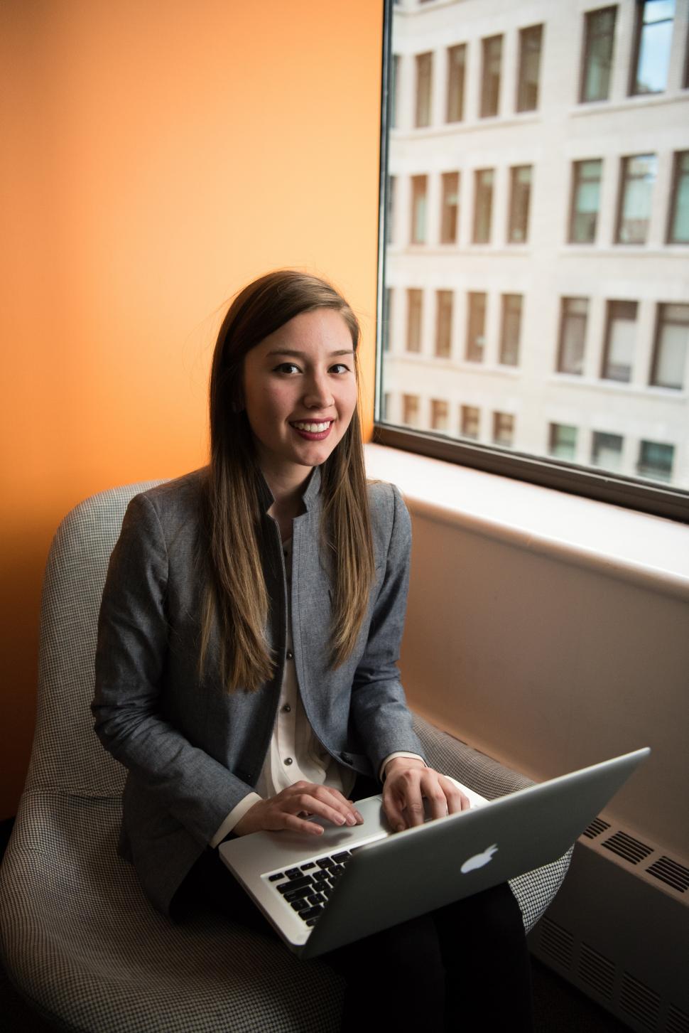 Free Image of Female using laptop near window in office 