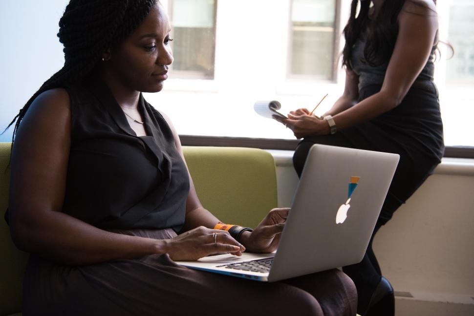 Free Image of Two business women with laptop and notepad 