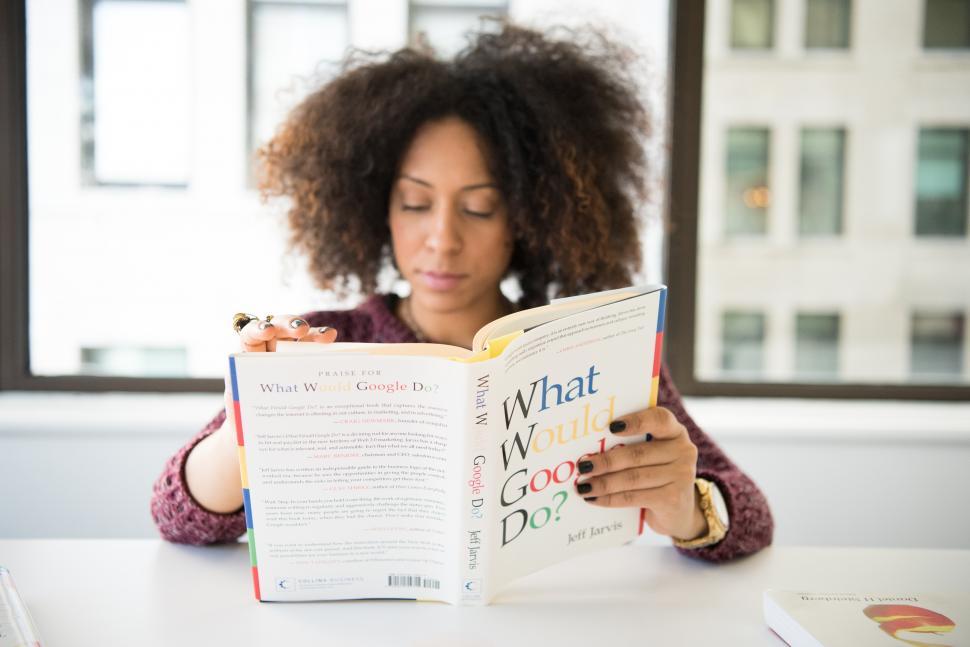 Free Image of Female developer with book - looking down 