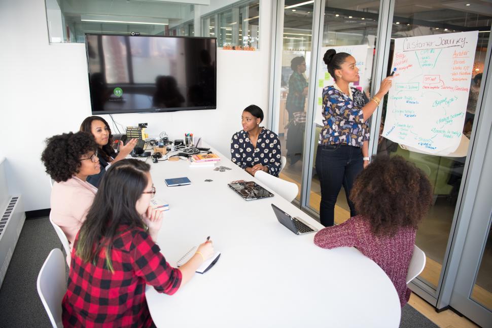 Free Image of Colleagues training with businesswoman in meeting room 