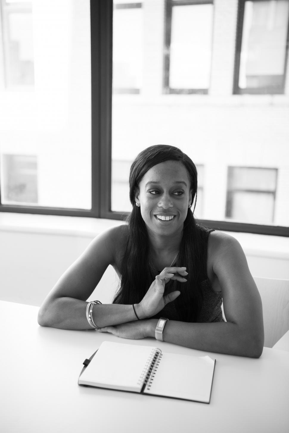Free Image of Happy Businesswoman with diary in office - b&w 