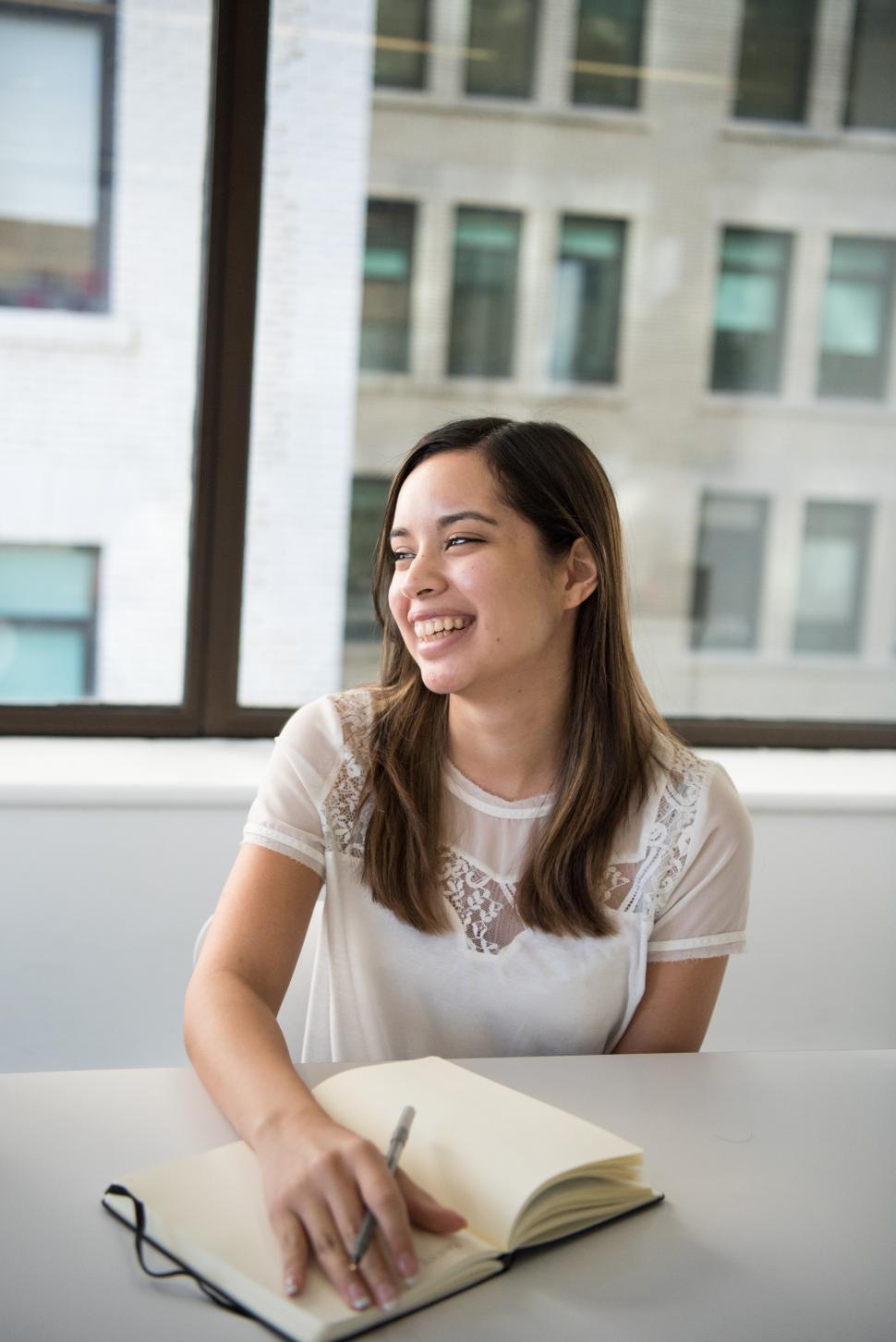 Free Image of Happy business woman with pen and diary 