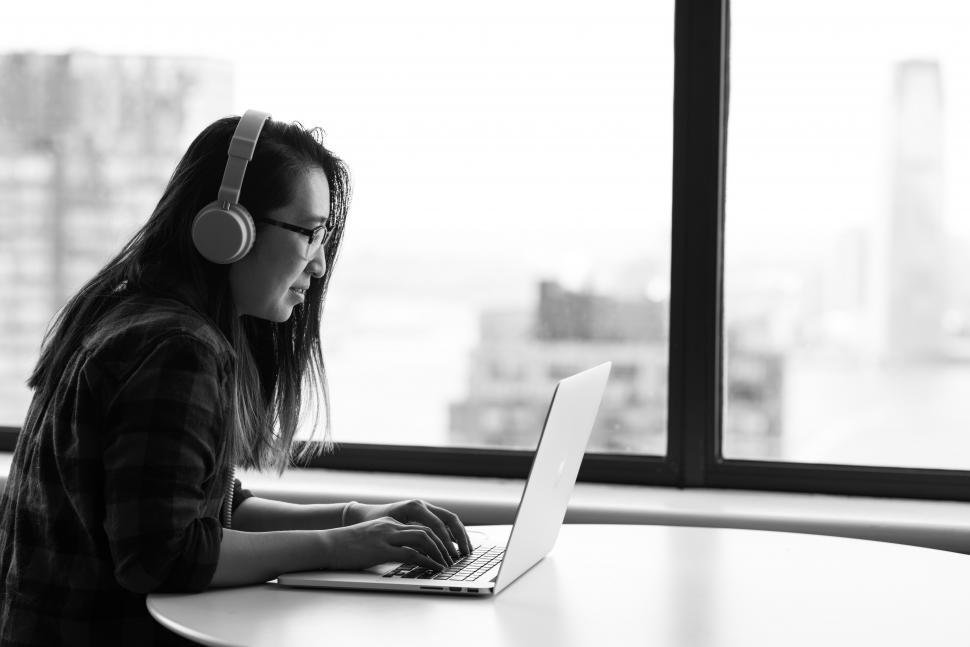 Free Image of Female executive in glasses using laptop in office 
