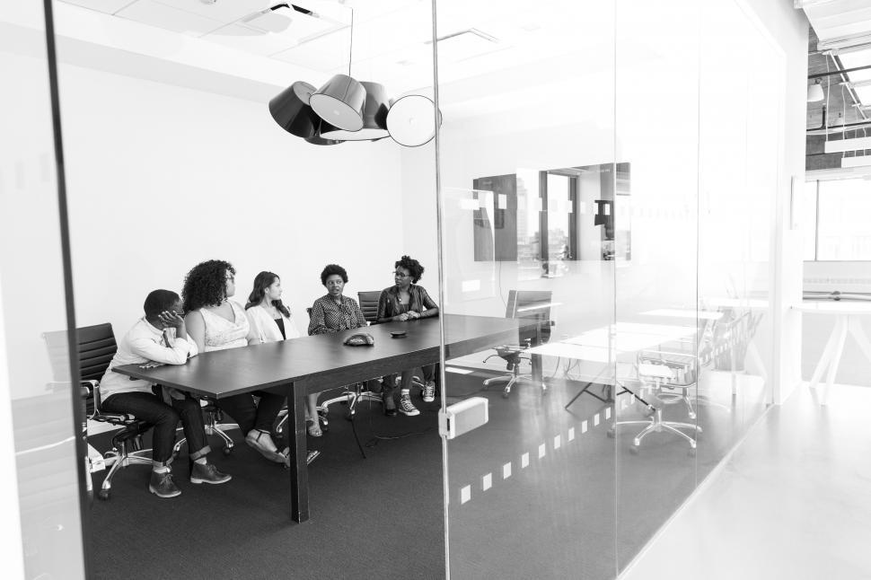 Free Image of Business people sitting in front of television for video call in 
