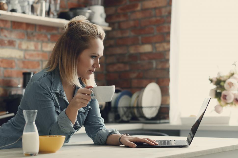 Free Image of Woman drinking coffee and browsing the internet 