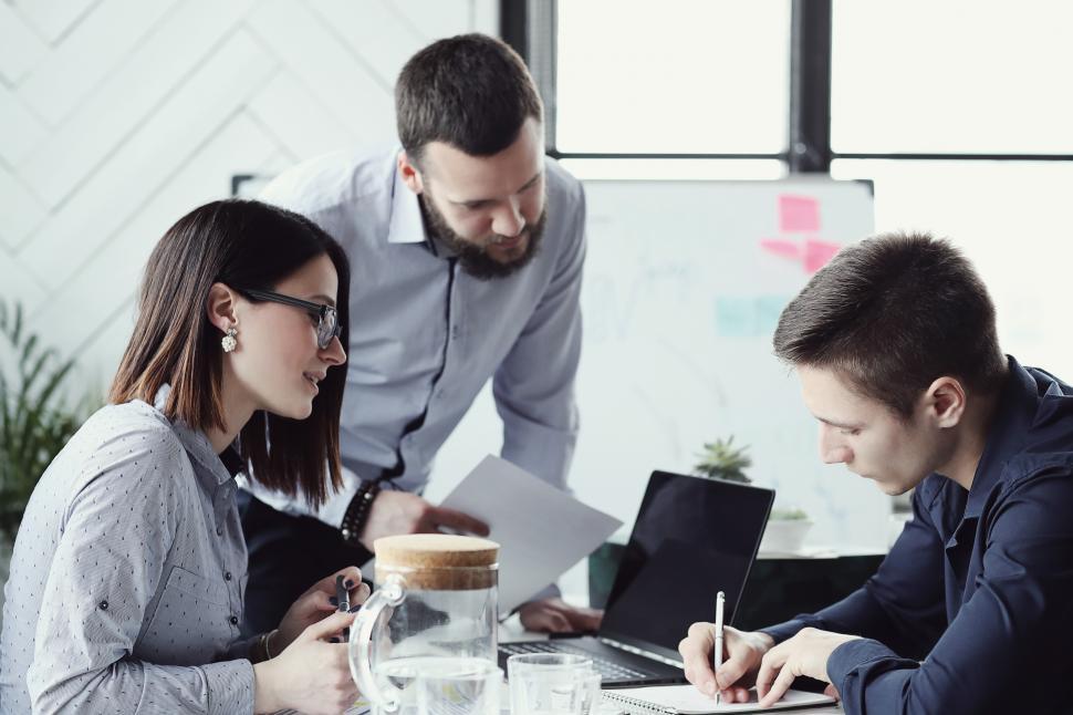 Free Stock Photo of Business people gather around a desk | Download ...