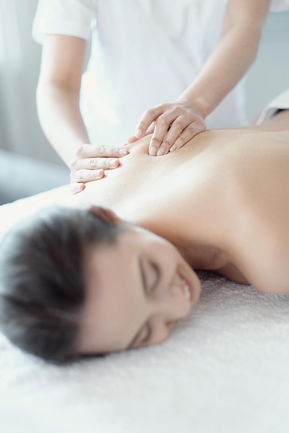 Beautiful Woman Receiving a Relaxing Back Massage at Spa. Stock