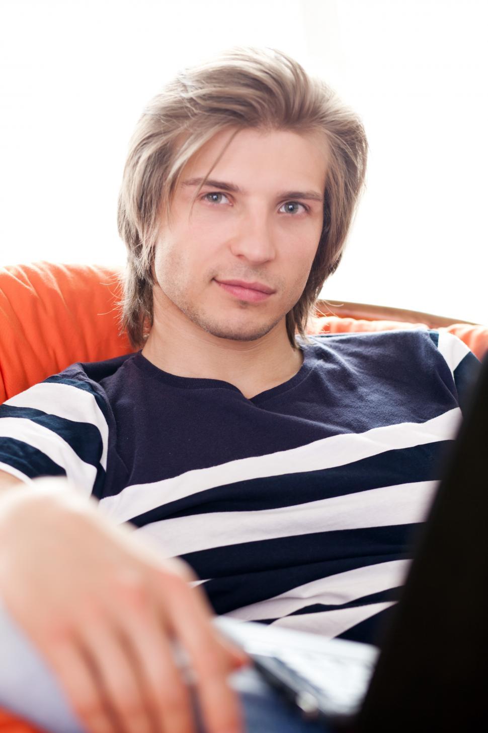 Free Image of Happy handsome guy relaxing with laptop 