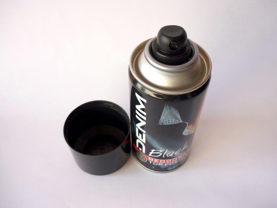 Free Image of Spray Paint Can Beside Cup 