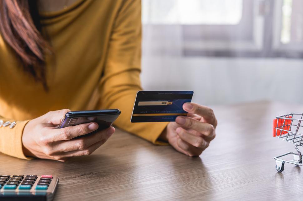 Free Image of Womens hands in yellow shirt holding Mobile Phone 