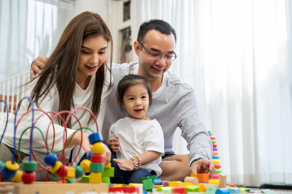 Free Stock Photo of Happy young father and mother and a little daughter ...