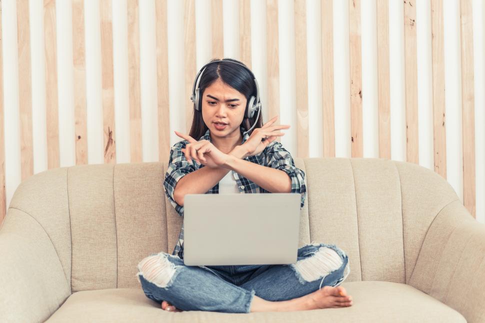 Free Image of Asian woman in jeans and plaid shirt 