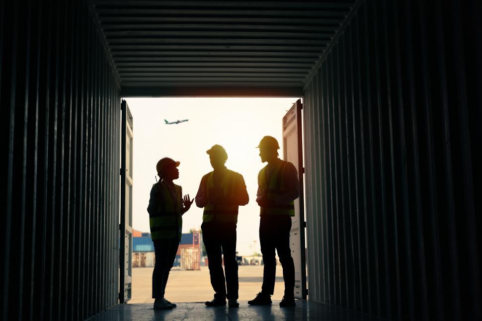 Free Image of Group of staff standing in silhouette 