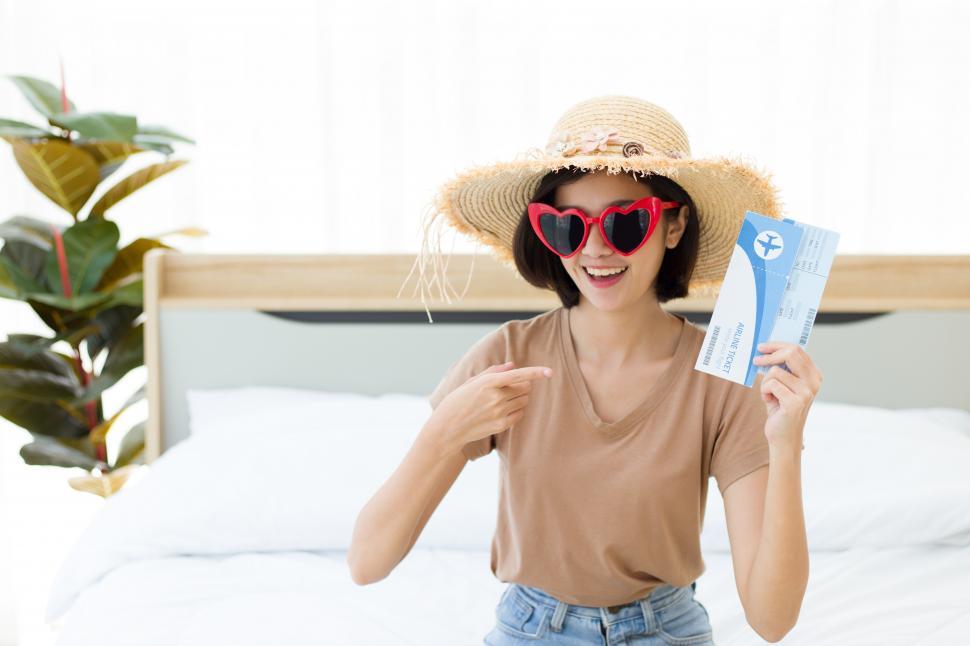 Free Image of Young woman with a plane ticket. 