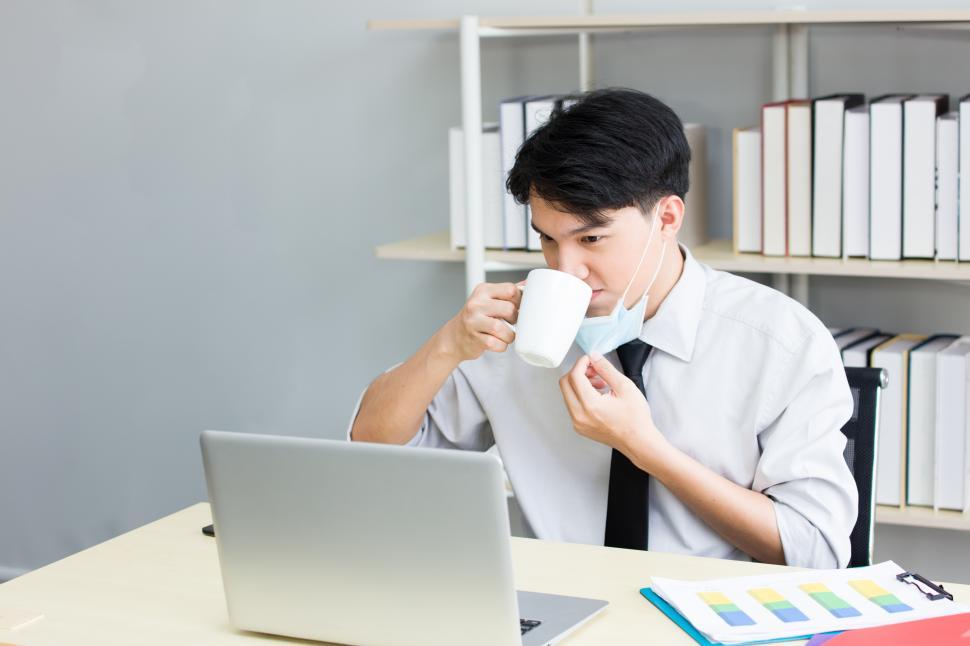 Free Image of Asian young man is working happily in the office. 