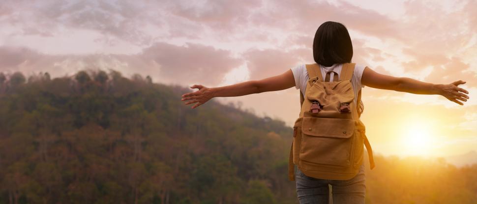 Free Image of Tourist watching sunset on the top of mountain 
