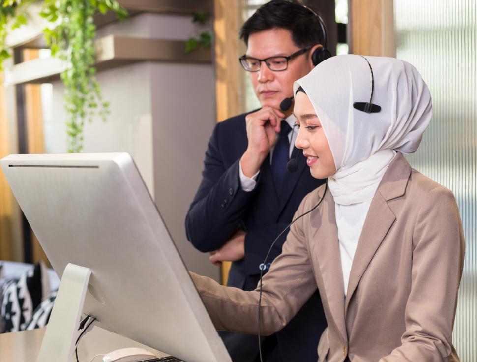 Free Image of Woman in headset working on a computer 