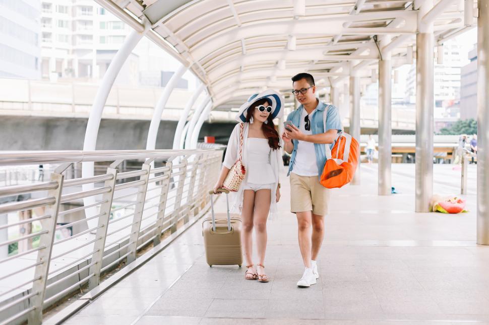 Free Stock Photo of Tourists holding a phone to search the map ...