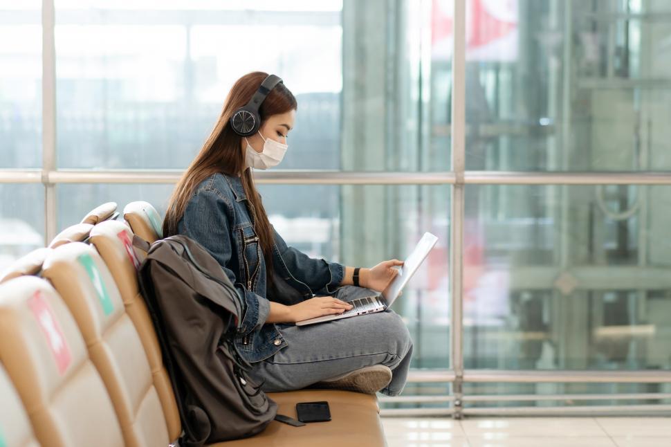 Free Stock Photo of Tourist traveller using laptop at the airport Download Free Images and