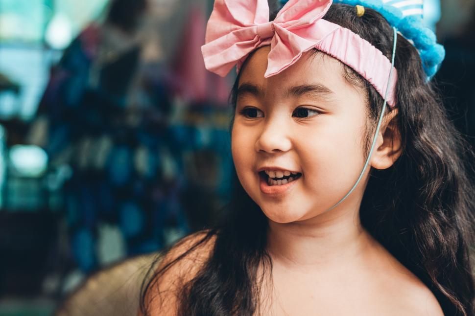 Free Image of Playful girl wearing dress with pretty headwear 