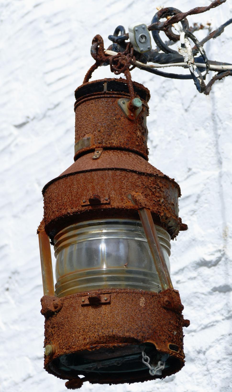 A Old Rustic Oil Lantern On A Wood Block At A Camping Site Stock