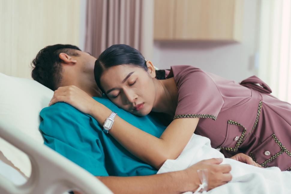 Wife embrace sick husband on bed