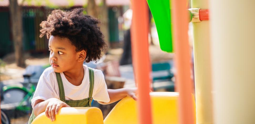 Free Image of Cute little kid climbing a playground slide 