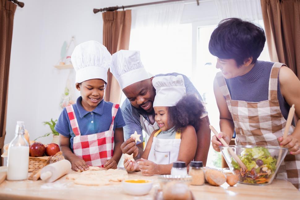 Free Image of Family cutting cookie dough shapes 