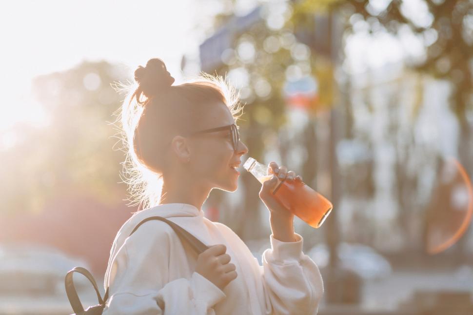 Free Stock Photo of Happy student drinks juice in the evening backlight ...