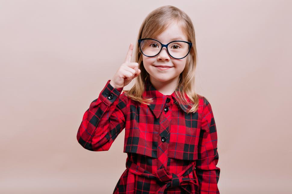 Free Image of Little girl raises up one finger 