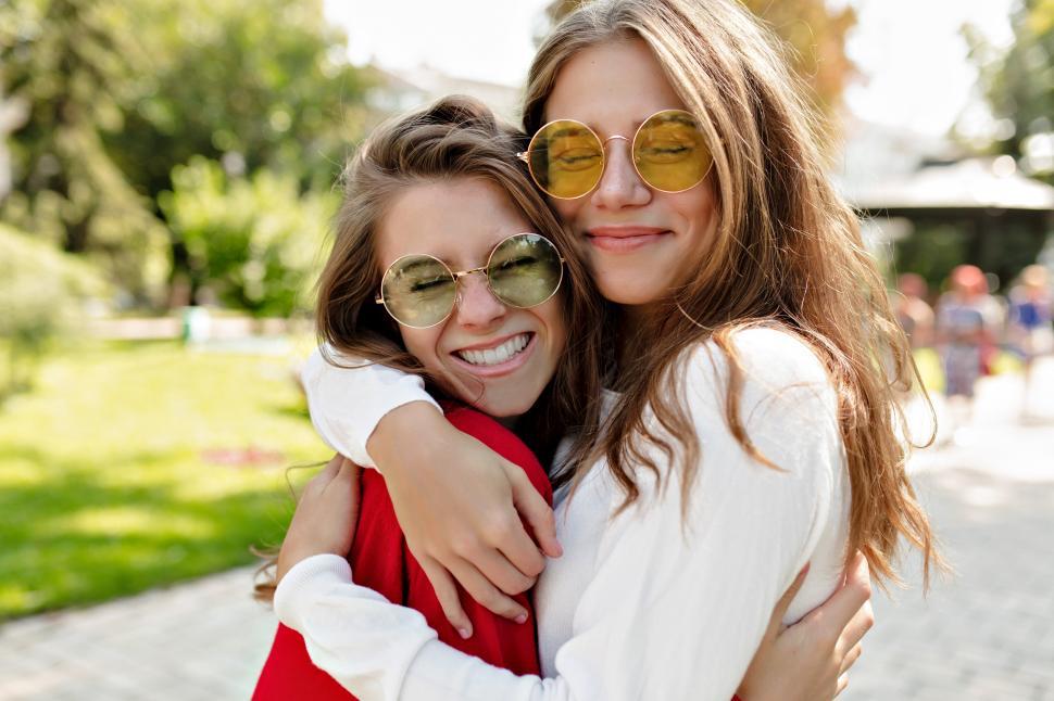 Free Image of Girls hugging each other with true smiles 