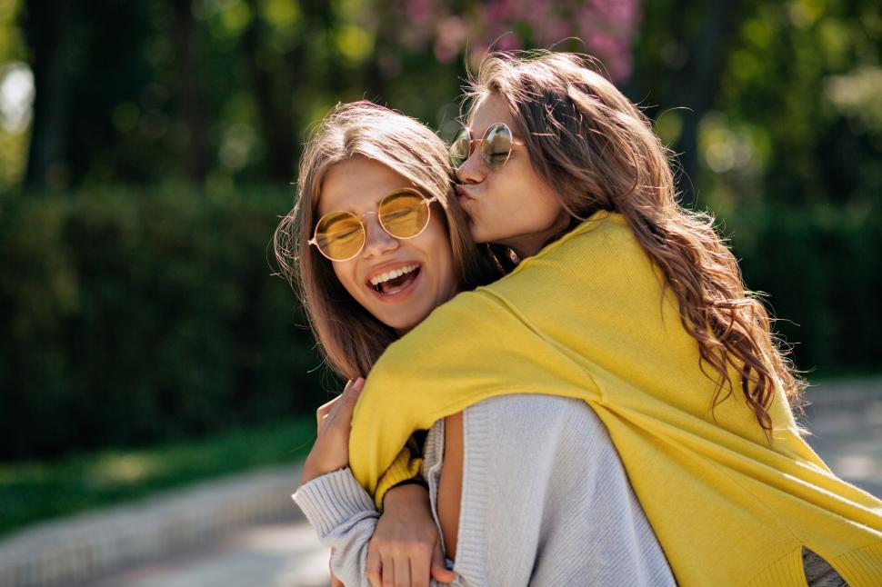Free Image of Lifestyle portrait of two happy inspired teen friends 