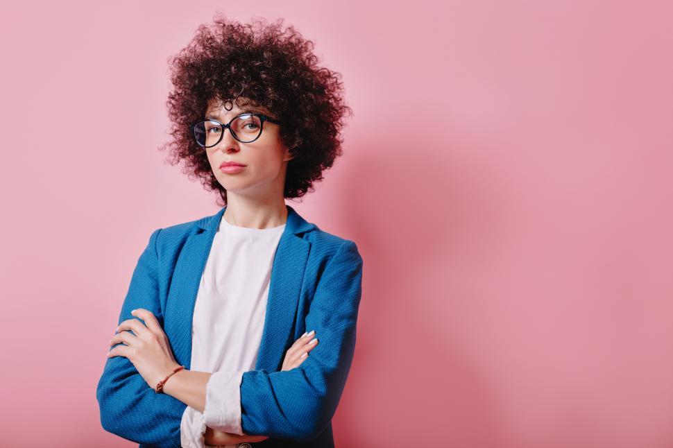 Free Image of Portrait of curly haired woman dressed in blue jacket 