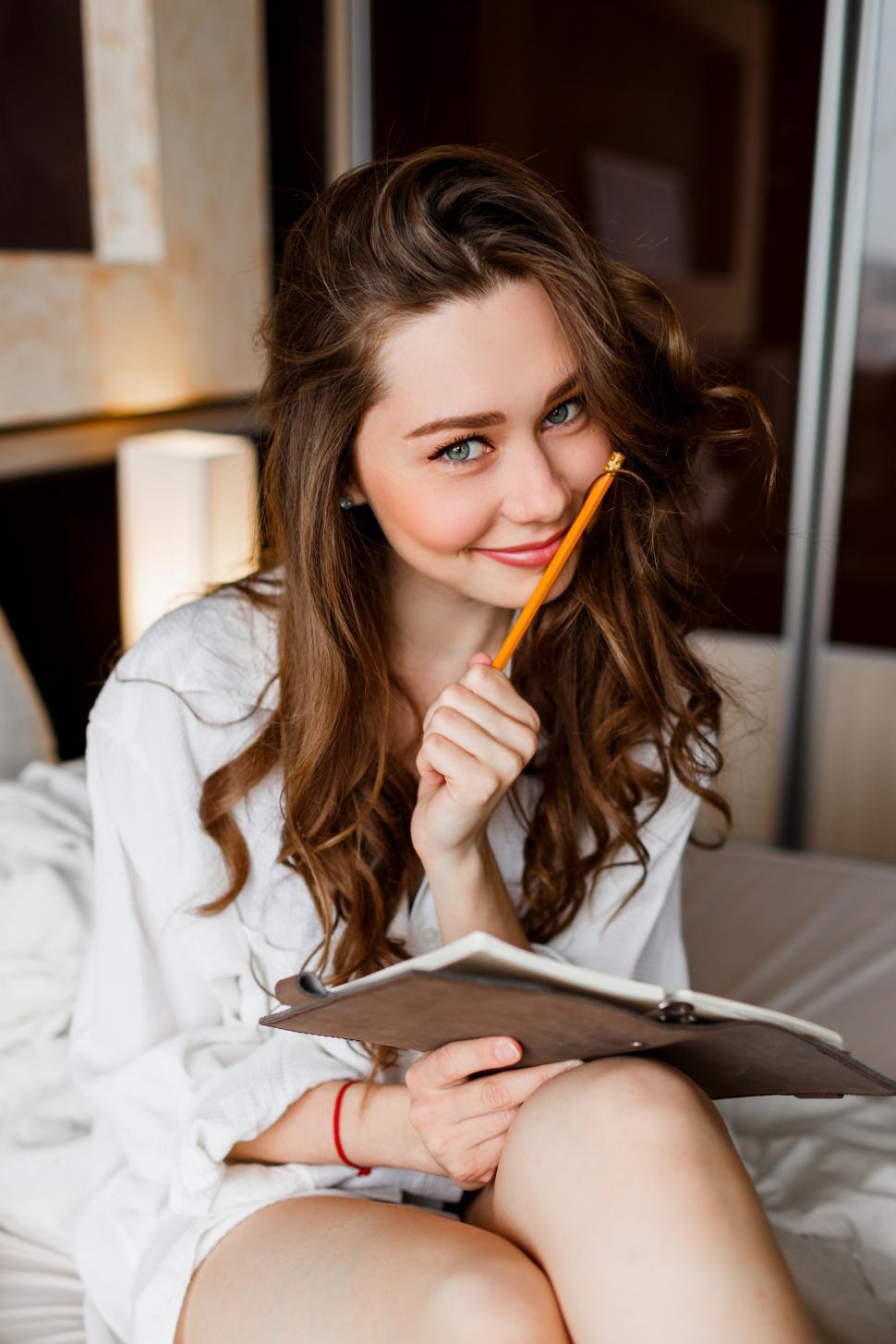 Free Image of Lifestyle portrait of young  beautiful woman in white shirt 