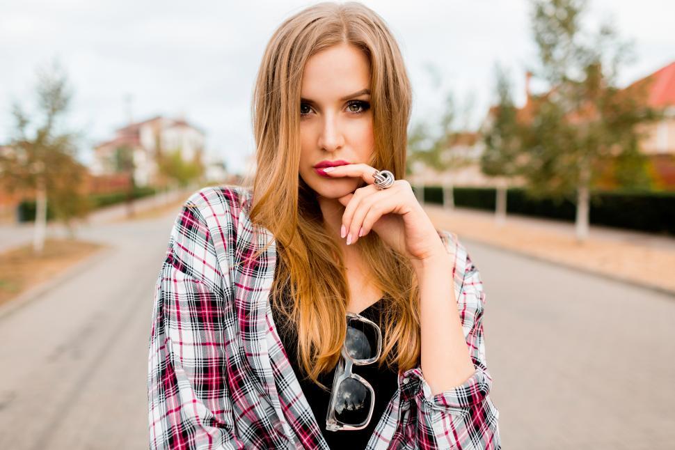 Hipster Girl with Long Blonde Hair Wearing Trendy Plaid Jacket
