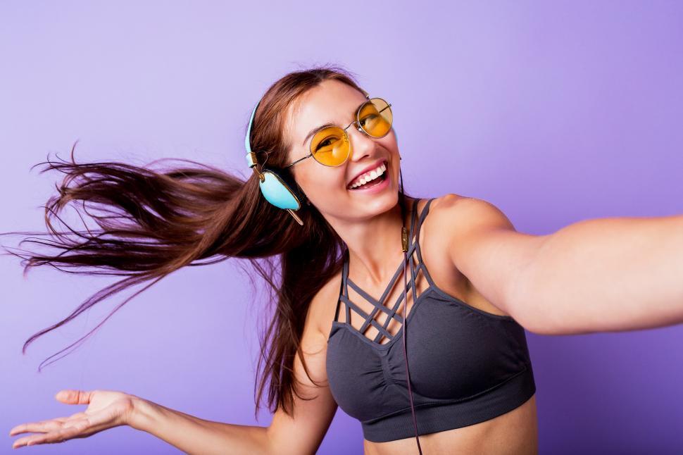 Free Photo  Sports girl training with phone and headphones