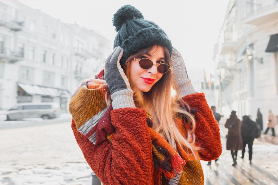 Happy beautiful girl smiling and looking up in stylish winter