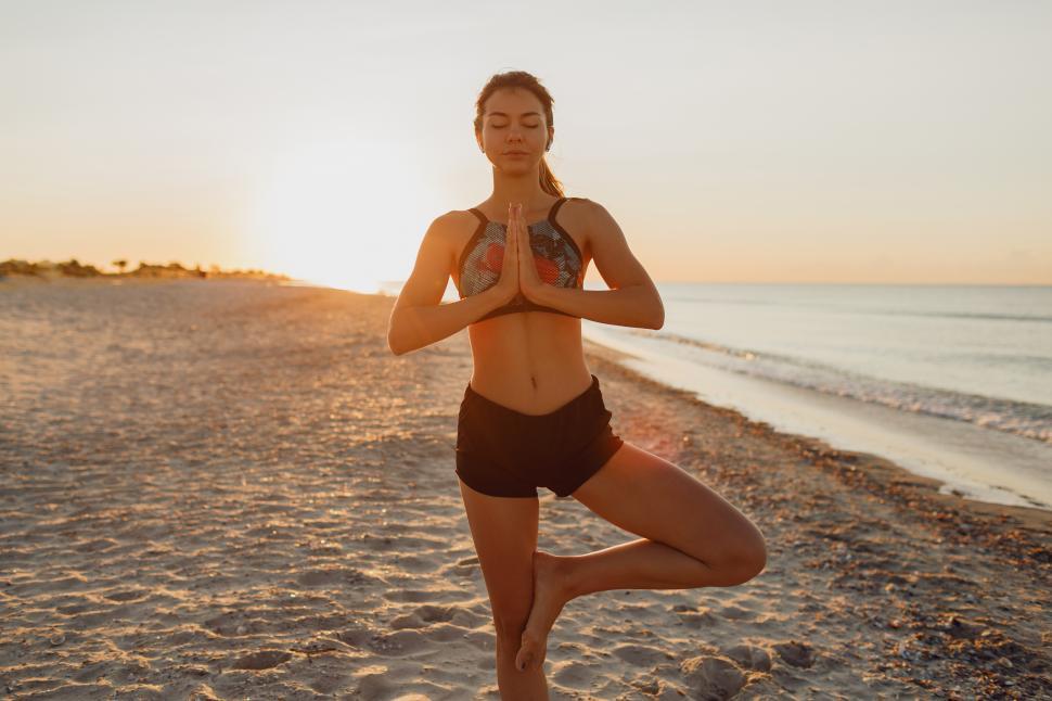 Free Stock Photo of Slim woman practicing yoga at the beach