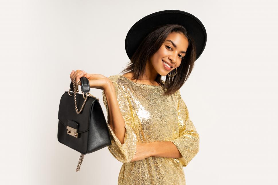 Free Image of Woman in golden party dress posing on white background 