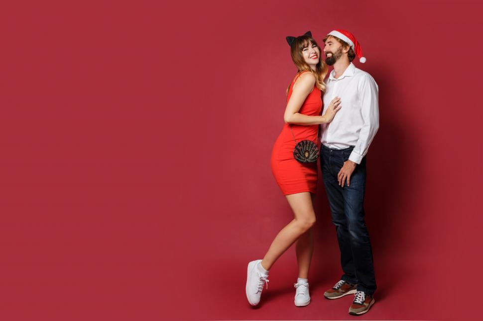 Free Image of Holiday party couple on red background 