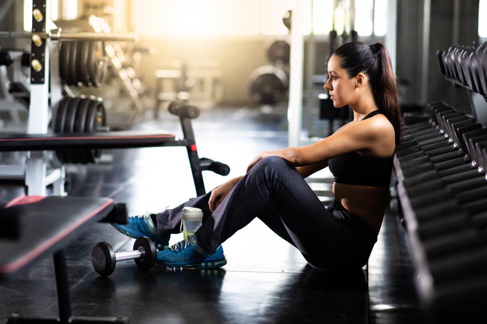 Free Stock Photo of Female athlete taking rest after exercising at gym ...