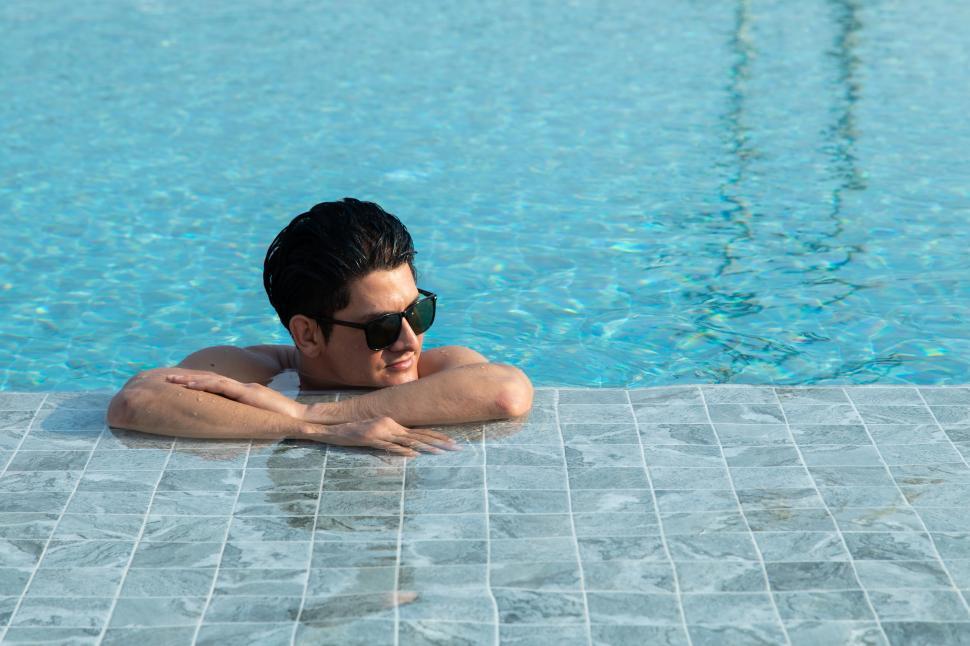 Wet And Shirtless Man Touching Seductive Woman In Swimsuit Stock